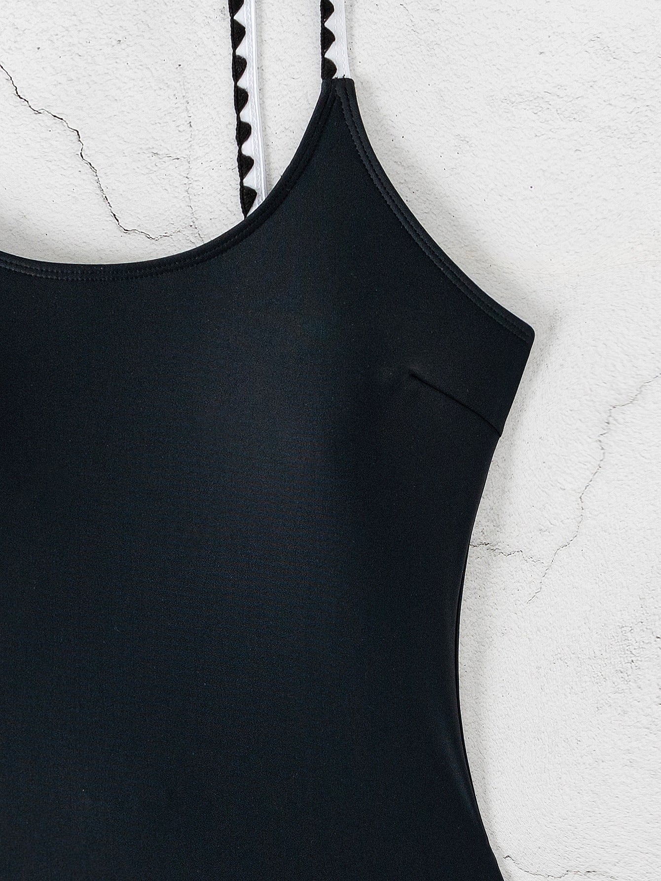 2025 Detail Front view of black one-piece swimsuit deep scoop back